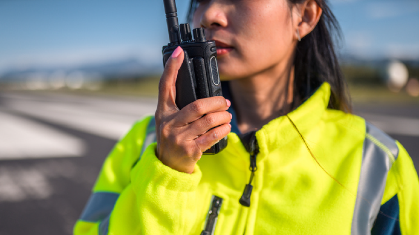 woman woker on jobsite using Stallion IS two way radio equipment