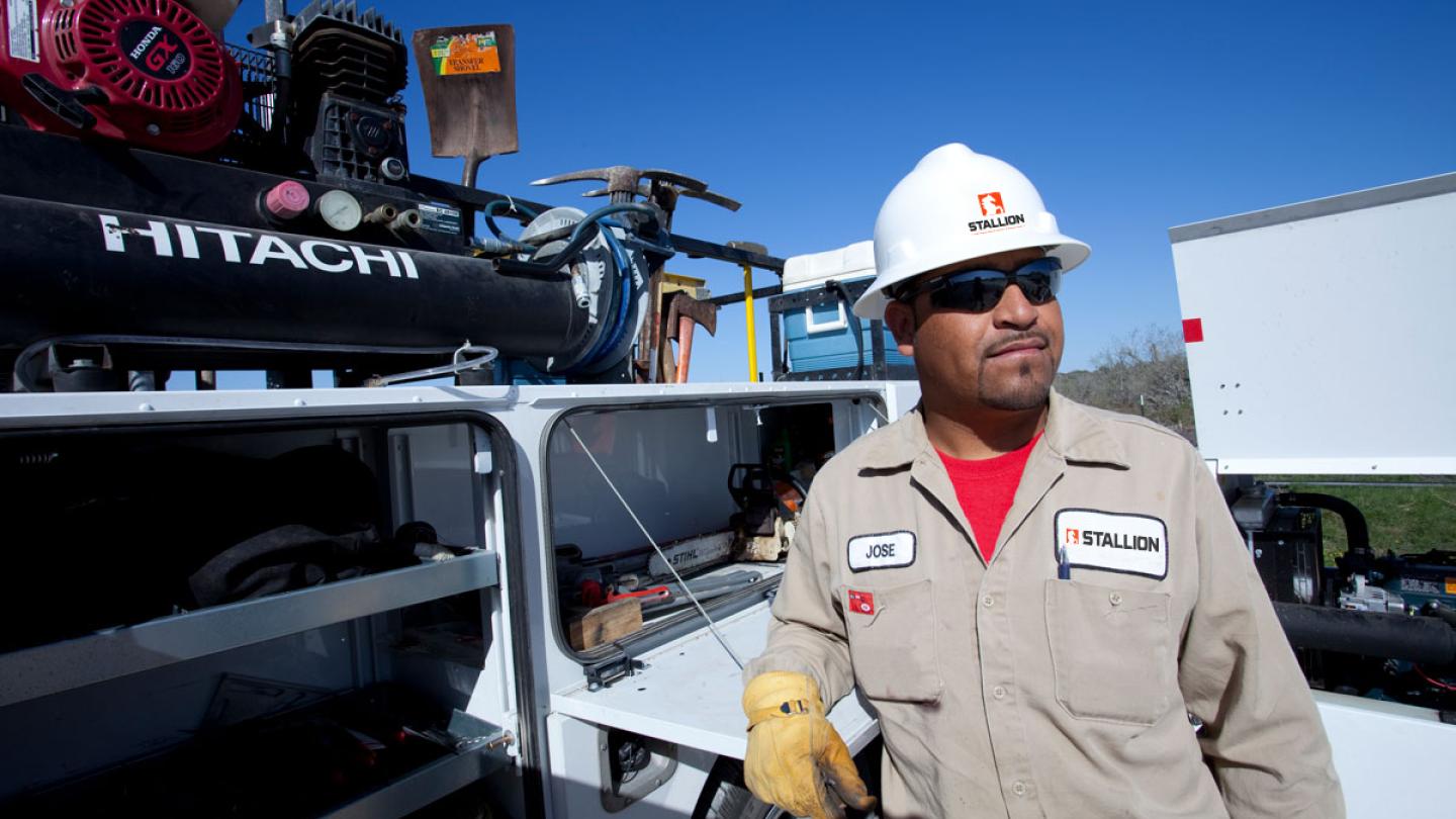 Construction worker next to equipment